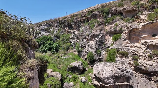 Wied il Mielah, Gharb, Gozo - Valley near limestone natural arch on the north-western coast of the island of Gozo in Malta. High quality 4k footage