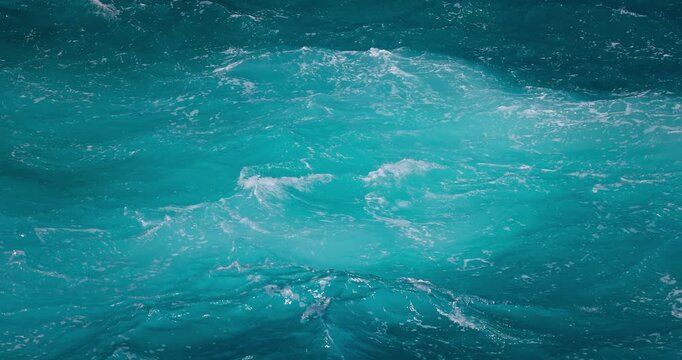 Splashing blue ocean water nature background with sea foam and churning waves