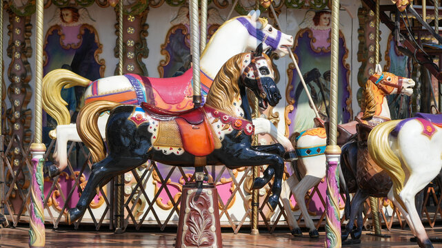 colorful vintage carousel with painted wooden horses at a traditional fairground