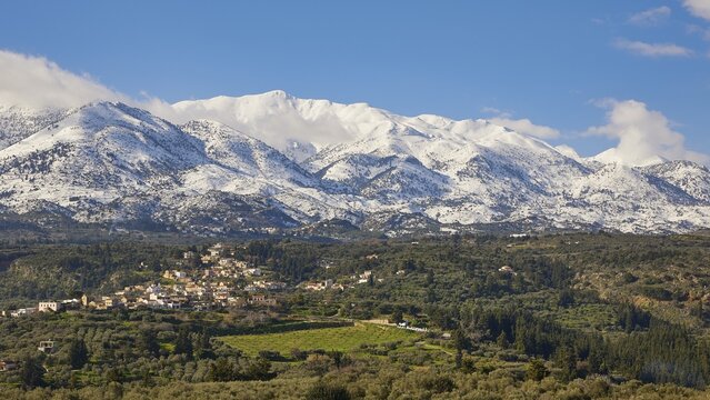 Winter landscape, snow-capped White Mountains, Lefka Ori, village, green fields, olive groves, blue hummel, clear weather, Apokoronas, Chania province, Crete, Greece