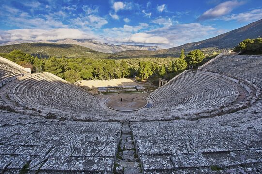 Old amphitheatre surrounded by nature, with views of mountains under a cloudy sky, UNESCO World Heritage Site, Epidaurus, Epidaurus, Ancient Amphitheatre, Peloponnese, Greece
