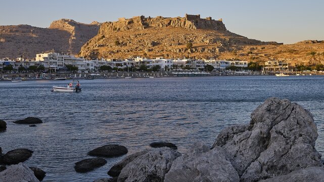 Feraklos fortress, coastal town with a castle above the evening sky and rocks on the shore, bay, Charaki, Haraki, east coast of Rhodes, Rhodes, Dodecanese, Greek Islands, Greece