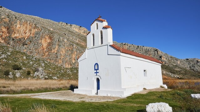 Agiou Petrou Chapel, Chapel of St Peter, A solitary whitewashed chapel stands against a mountainous backdrop, Strofilia biotope, wetlands, Kalogria, Peloponnese, Greece