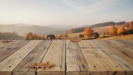 Obraz premium Wooden table top with autumn leaves and rural landscape background