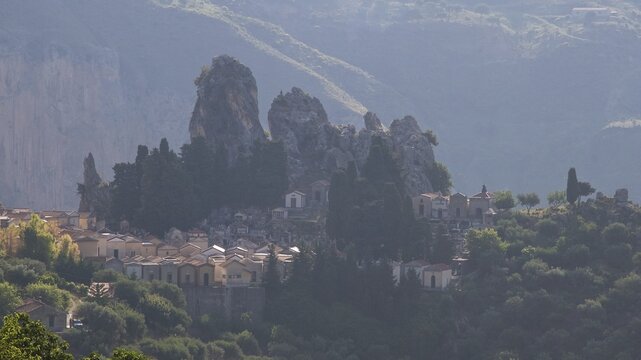 Backlight in the morning, Bizarre rocks, Mountain in the background, Cemetery, Militello Rosmarino, Village, Nebrodi National Park, Sicily, Italy