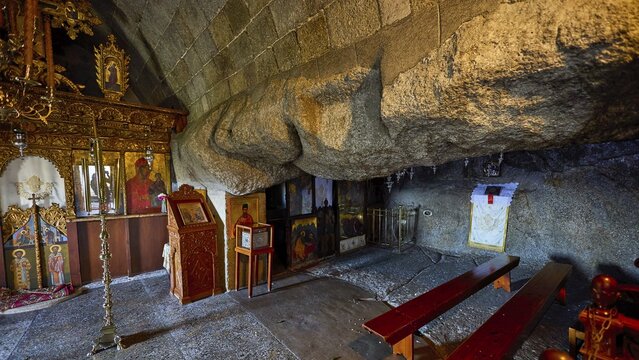 Church interior with icons and wooden benches set into a stone wall, Cave of St John, Grotto of Spileo Apokalipsis, Monastery of the Revelation, Moni tis Apokalipsis, World Heritage Site 1999, Patmos, Dodecanese, Greek Islands, Greece