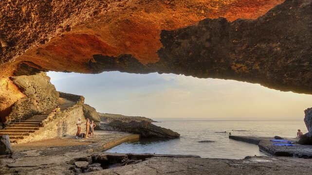 Spiaggia Sataria, evening light, grotto by the sea, stairs, view outside, peoplePantelleria, Pelagic Islands, Sicily, Italy