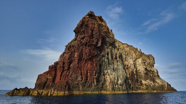 Strombolicchio islet, large rock in the sea under a blue sky, reminiscent of volcanic landscape, UNESCO World Heritage Site, Aeolian Islands, Aeolian Islands, Sicily, Italy