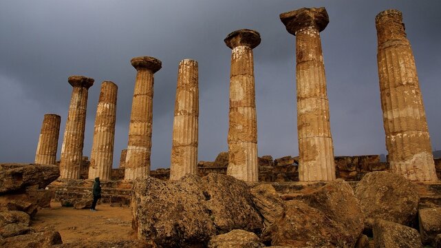 Row of columns, chapter, Heracles temple, dark clouds, sun, thunderstorm atmosphere. Valley of the temples, valle dei templi, Agrigento, Sicily, Italy