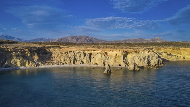 Wide view of a calm coast with cliffs and mountains in the background, drone shot, evening light, Araki Beach, southwest coast, Karpathos, Dodecanese, Greek Islands, Greece