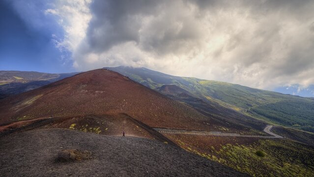 Volcanic hill with steep slope and clouds in the sky, UNESCO World Heritage Site Etna, volcano, volcanism, Sicily, Italy