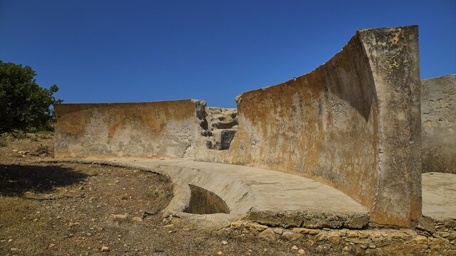Semi-circular, weathered concrete wall in sandy surroundings, Lost Place, Air Defence Position, Aerophone, Parabolic Acoustic Mirror, Patella Mountain, WW2, west of Lakki, Leros, Dodecanese, Greek Islands, Greece