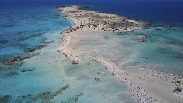 Overtourism, tourists on the beach, parasols, A peninsula with a sandy beach jutting out into the blue sea, a perfect holiday destination, Elafonissi, lagoon, south-western tip of Crete, Crete, Greek islands, Greece