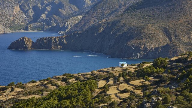 Hilly landscape with sea view and inserted house in the grass, Mesochori village, West Coast, Karpathos, Dodecanese, Greek Islands, Greece