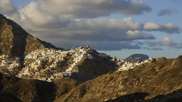 An expansive village view in the mountains under a dramatic cloudy sky, Colourful mountain village, Morning light, Olymbos, Karpathos, Dodecanese, Greek Islands, Greece