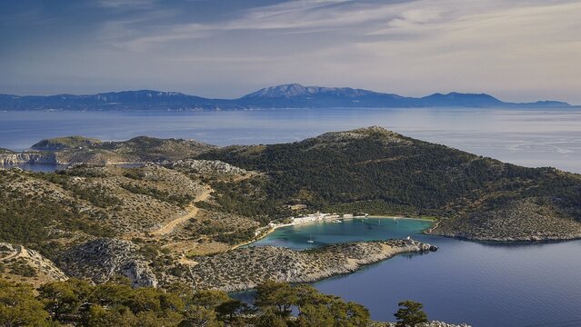 View of a coastal landscape with hilly vegetation and blue water, Holy Week, Bay of Panormitis, Panormitis Monastery, Symi, Dodecanese, Greek Islands, Greece