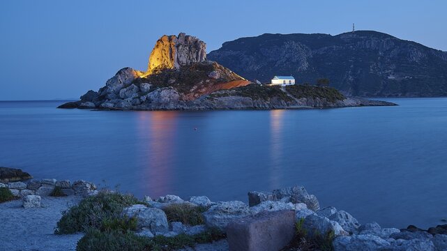 Impressive shining rock on an island at dusk with calm sea, Agios Stefanos Beach, Agios Stefanos Basilica, Chapel Agios Nikolaos, Kastri Island, Kos, Dodecanese, Greek Islands, Greece