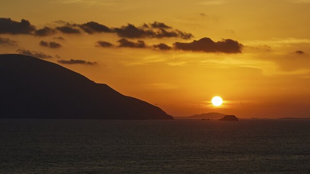 Still life of a sunset over the sea with mountains on the horizon and a sky in yellow and orange, sunset, Kassos, Karpathos, offshore islands, Dodecanese, Greek Islands, Greece