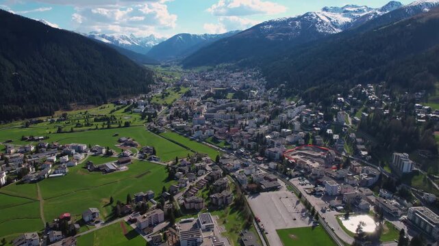 Aerial panoramic view above the downtown around the city Davos in Switzerland on a sunny summer afternoon. 