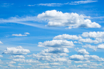 Obraz premium Dramatic white cumulus clouds floating across deep blue summer sky natural weather background scenic view