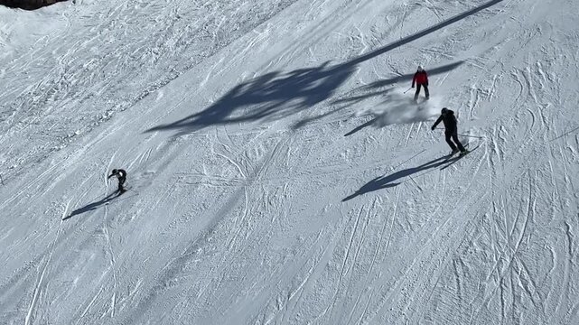 Amidst glowing sunshine, daring skiers navigate down pristine slopes, leaving trails in the untouched snow. Laughter fills the air as friends share excitement in this winter wonderland.