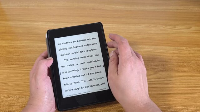 Person reading a digital tablet with e-book technology, modern electronic reading device