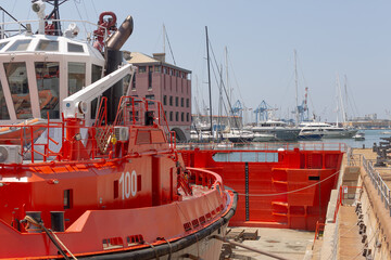 Red tugboat located out of the water in a dry dock in the port of Genoa