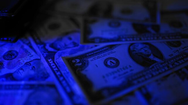 Police seized illegal money, smuggling. A close-up of the shadow market and dirty dollar bills used by criminals and scammers for laundering.