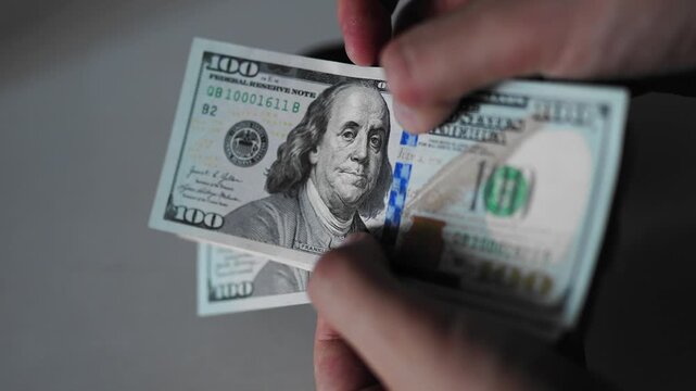Police seized illegal money, smuggling. A close-up of the shadow market and dirty dollar bills used by criminals and scammers for laundering.