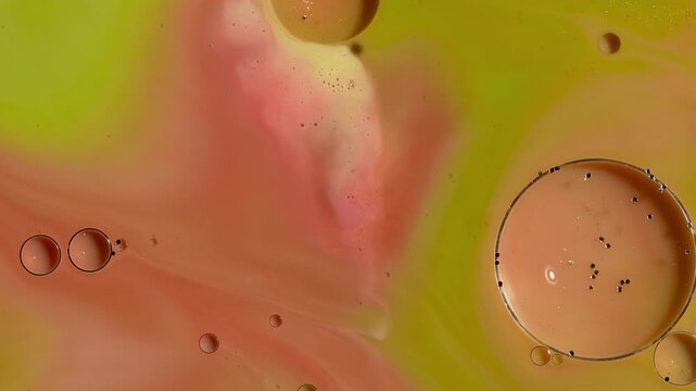 Abstract Fluid Art Macro - Swirling Lime Green and Peach Paint with Glitter Oil Spheres