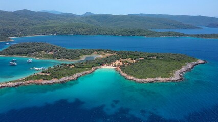 Fototapeta premium Flying towards Cleopatra Beach famous for its white, fine and soft sand beach, surrounded by azure and turquoise blue waters. Aerial View of Sedir Island. Mediterranean Sea, Gulf of Gökova, Turkey