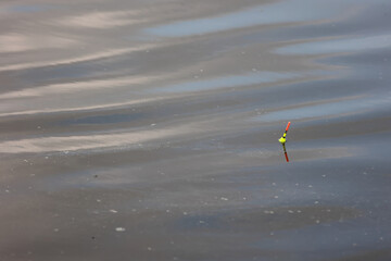 Fishing float bobbing on calm water surface © k49red