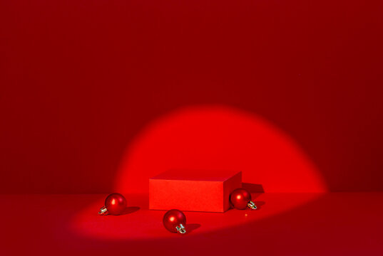 Red Christmas Product Podium with Ornament Balls and Circular Spotlight on Red Background