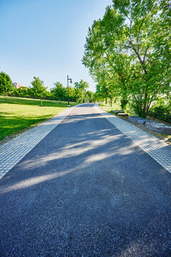 The paved pedestrian path running through Corning Preserve (aka Jennings Landing) along the Hudson River waterfront in Albany, New York