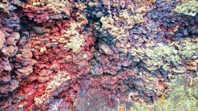 Vibrant colored lava rock formation at Craters of the Moon National Monument and Preserve in Idaho showing volcanic textures and mineral tones