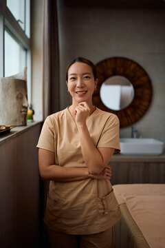 Happy female wellness therapist at work looking at camera.