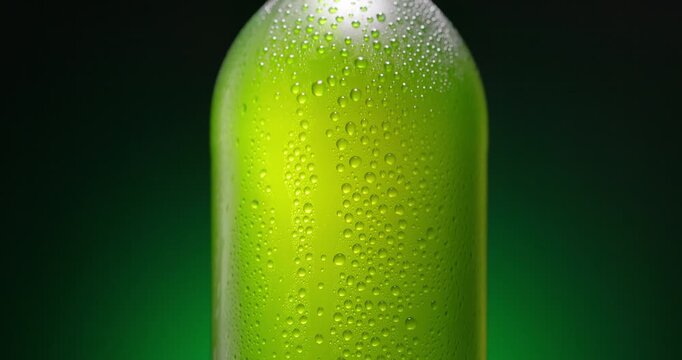 Cold Beer Bottle With Condensation Droplets on the glass On green Background cinematic video
