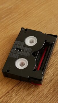 Compact video cassette landing on table