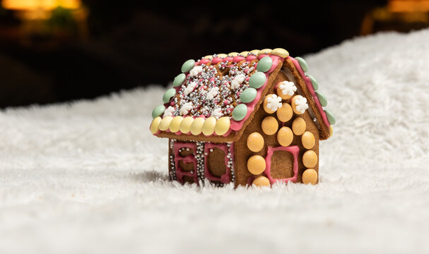 Decorated gingerbread house with candy details in soft winter light.