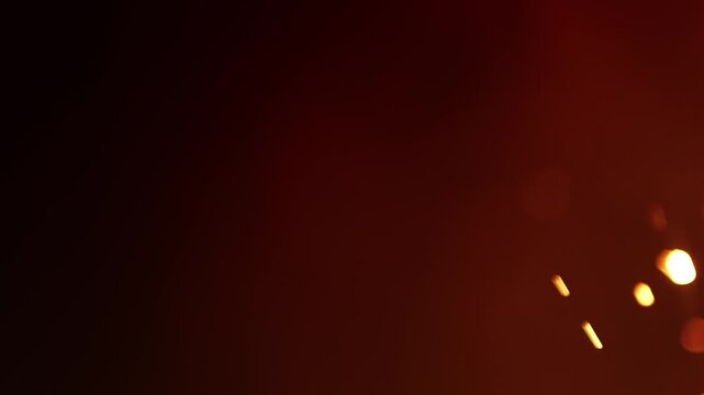 Hellish hot fiery background with smoke and sparks. Out of focus blazing fire creating an atmosphere of warmth and heat. Orange glow of flickering flames. Hell fire backgrounds in seamless loop.