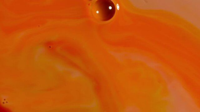 Abstract Fluid Art Macro - Swirling Orange and Crimson Paint Waves with Oil Droplet
