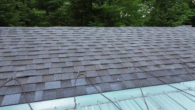 Inspecting a house shingles roof with a drone