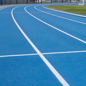 Renaissance Stadium Jog. Outdoor Stadium Running Track With Blue Asphalt And White Markings