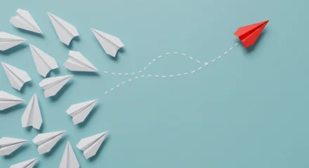 red paper airplane changing direction from white planes leadership concept © latifah