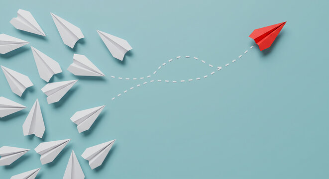 red paper airplane changing direction from white planes leadership concept
