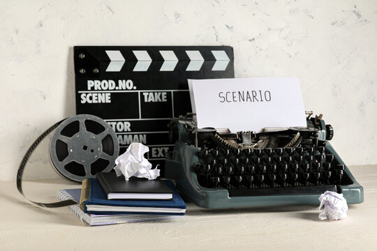 Vintage typewriter with scenario paper and film clapperboard
