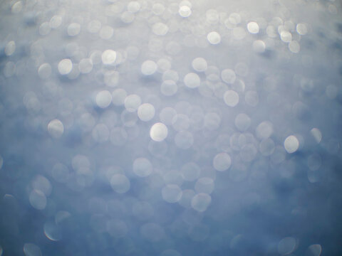 Water droplets on dark surface. Raindrops glisten under soft light. Smooth texture with shallow depth of field. Moody, atmospheric, close up shot. Ideal for nature, weather, or design projects