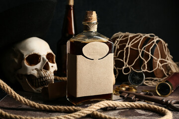 Rum with key and rope on map, closeup. Pirate concept © Pixel-Shot