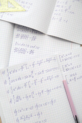 Obraz premium Open copybooks with math formulas as background, closeup