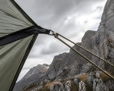 Strong Paracord Guylines Pulled Taut From A Tent Corner Displaying Perfect Tension And Structural Geometry